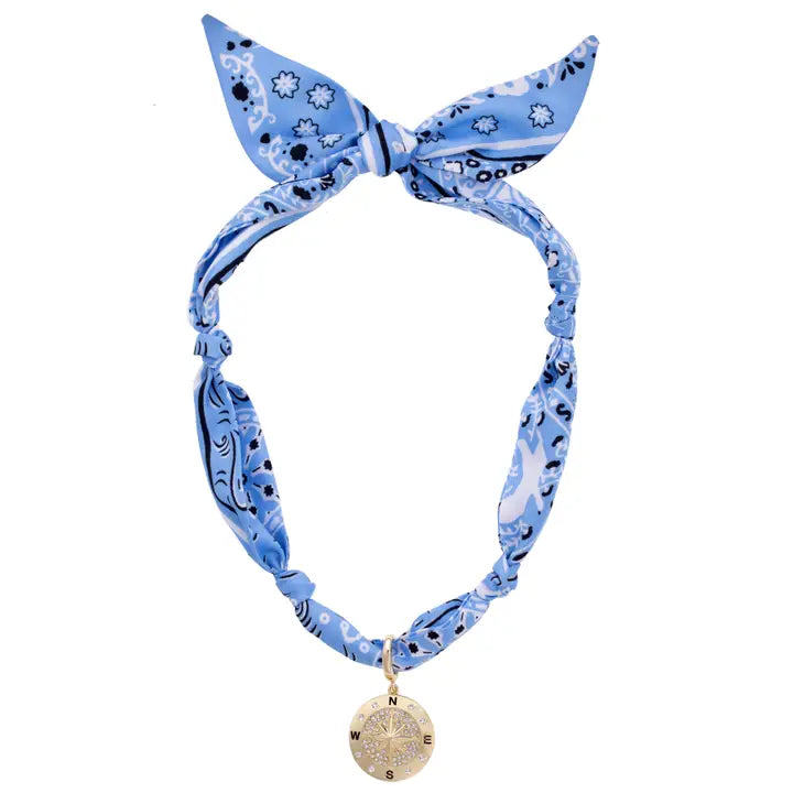 Blue patterned headband with a gold pendant on a white background