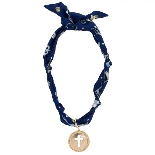 Navy blue headband with white patterns and a gold cross pendant on a white background